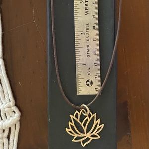 Gold lotus on leather cord